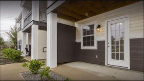 Augusta apartment for rent - A house with a white door and a small garden in front.