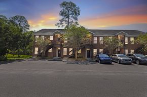 Pembroke apartment for rent - a large apartment building with cars parked in front of it