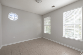 Pembroke apartment for rent - A room with a hexagonal window and a window with blinds.