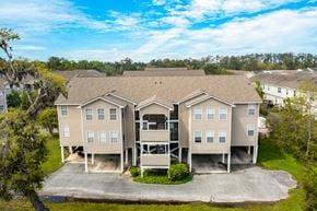 Savannah apartment for rent - A large, two-story residential building with a driveway in front.