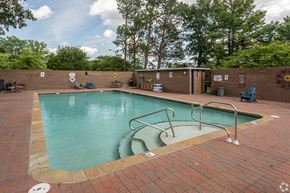 North Little Rock apartment for rent - a swimming pool with a brick wall and a fence around it