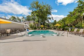 Savannah apartment for rent - a pool with lounge chairs and umbrellas