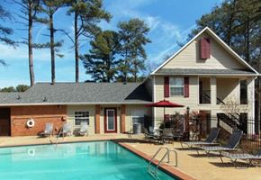 Lawrenceville apartment for rent - A house with a pool in front of it.