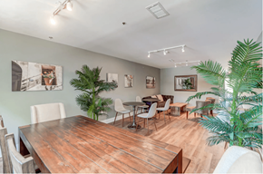 Charleston apartment for rent - a dining room with a wooden table and chairs and plants