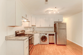 Charleston apartment for rent - a kitchen with white cabinets and stainless steel appliances