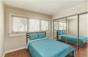 Charleston apartment for rent - a bedroom with two beds and a mirrored closet