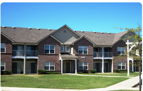 Memphis apartment for rent - A large brick apartment building with a green lawn in front.