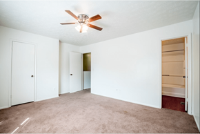 Douglasville apartment for rent - A room with a ceiling fan and carpeted floor.