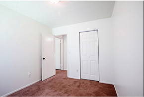Douglasville apartment for rent - A room with a brown carpet and white walls.