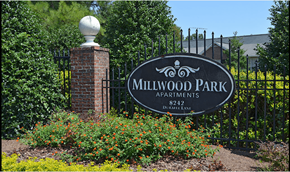 Douglasville apartment for rent - A sign for Millwood Park apartments stands in front of a fence.