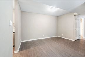 Macon apartment for rent - an empty living room with white walls and wood floors
