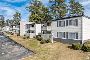 Covington apartment for rent - a row of white apartment buildings with trees in the background