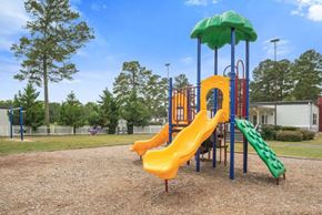 Macon apartment for rent - a playground with a swing set and slides