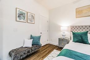 Bentonville apartment for rent - a bedroom with two beds and a nightstand with a lamp