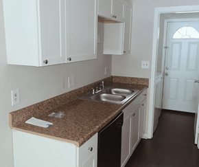 Myrtle Beach apartment for rent - A kitchen with brown granite countertops and white cabinets.