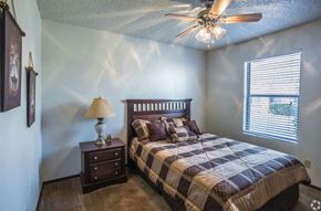 Little Rock apartment for rent - a bedroom with a bed and a ceiling fan