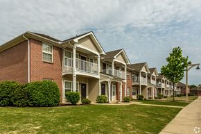 Memphis apartment for rent - A row of houses with a tree in front of them.