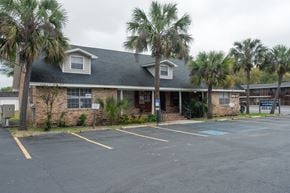 Pensacola apartment for rent - A building with a parking lot in front of it.