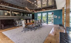 Alexander apartment for rent - a conference room with a long wooden table and chairs