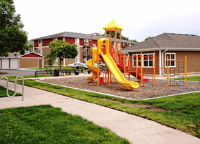 Des Moines apartment for rent - a playground in front of a building with a yellow slide