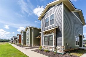 Alexander apartment for rent - a row of townhomes with a blue sky in the background