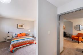 Greensboro apartment for rent - A bedroom with a bed and a chair in it.