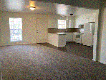 Sulphur apartment for rent - a view of a kitchen and a living room with a carpet