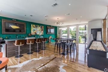 Alexander apartment for rent - a living room with a bar and a table with chairs