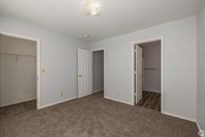 Branson townhouse for rent - a bedroom with two doors and a carpeted floor