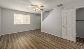 Branson townhouse for rent - an empty bedroom with a ceiling fan and a closet