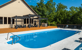 Branson townhouse for rent - a swimming pool with a pergola next to a house