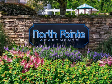 Gainesville apartment for rent - A sign for North Pointe Apartments is surrounded by flowers.