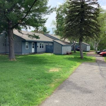 Caribou apartment for rent - a blue house with a sidewalk and some trees