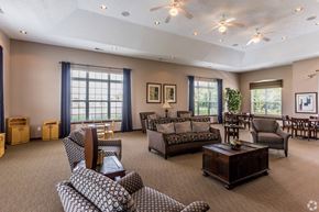 Memphis apartment for rent - A spacious living room with a variety of seating options and a large window.