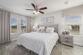 Gulf Breeze apartment for rent - a bedroom with a large bed and a ceiling fan