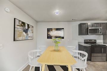 Savannah apartment for rent - A dining room with a wooden table and white chairs.