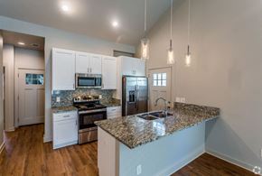 Alexander apartment for rent - a kitchen with white cabinets and a granite counter top