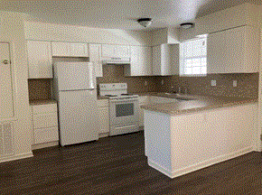 Sulphur apartment for rent - a kitchen with white appliances and white cabinets