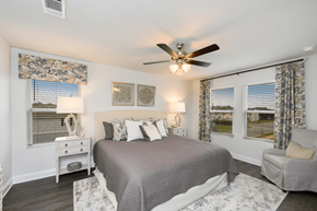 Crestview townhouse for rent - a bedroom with a bed and a ceiling fan