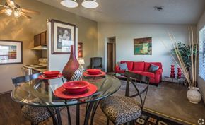 Little Rock apartment for rent - a dining room and living room with a glass table and chairs