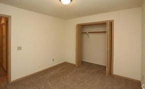 Oklahoma City townhouse for rent - a bedroom with a closet and a door to a closet