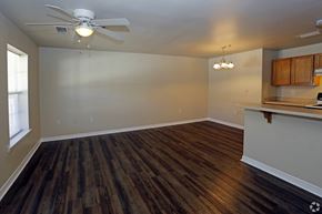 Foley apartment for rent - A room with a ceiling fan and wooden flooring.