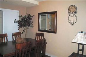Little Rock apartment for rent - a dining room with a table and chairs and a clock on the wall