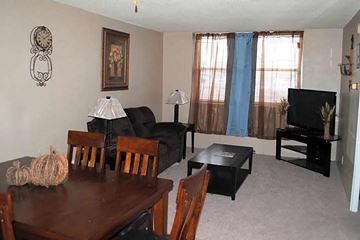 Little Rock apartment for rent - a living room with a dining room table and a television