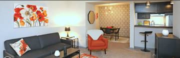 Greensboro apartment for rent - A living room with a couch, a chair, and a painting on the wall.