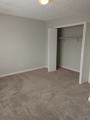 Canton apartment for rent - an empty living room with an open closet