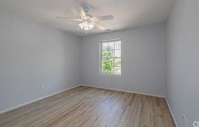 Branson apartment for rent - an empty room with a ceiling fan and a window