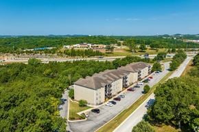 Branson apartment for rent - an aerial view of an apartment complex with trees and a blue sky in the background