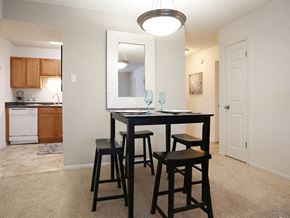 Destrehaun apartment for rent - a dining area with a table and chairs and a kitchen in the background