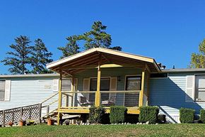 Acworth apartment for rent - a blue house with a yellow porch and a blue sky